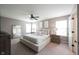 A main bedroom with neutral tones, carpet floors, ceiling fan and natural light at 5824 W Commonview Dr, McCordsville, IN 46055