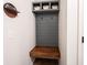 A mudroom area with wooden bench, coat hooks and overhead storage cabinets with baskets at 5824 W Commonview Dr, McCordsville, IN 46055