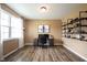 Bright home office with a large window, stylish shelving, and wood-look flooring for a productive workspace at 5824 W Commonview Dr, McCordsville, IN 46055