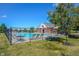 Community pool area with lounge chairs, table, and clear blue skies on a sunny day at 5824 W Commonview Dr, McCordsville, IN 46055