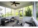 Relaxing screened-in porch offering a peaceful outdoor retreat with comfortable seating and ceiling fan at 5824 W Commonview Dr, McCordsville, IN 46055