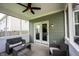 Cozy screened-in porch featuring outdoor seating and a ceiling fan, perfect for relaxation at 5824 W Commonview Dr, McCordsville, IN 46055