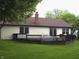 Home's backyard features a deck, lush lawn, mature trees, and partial fence at 60 Bittersweet Ct, Noblesville, IN 46062