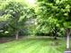 Expansive backyard features lush greenery, mature trees, and a well-maintained lawn at 60 Bittersweet Ct, Noblesville, IN 46062