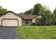 Charming single-story home with a well-maintained front lawn, attached garage, and beautiful landscaping at 60 Bittersweet Ct, Noblesville, IN 46062