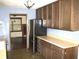 Functional kitchen with wooden cabinets, a laminate countertop, stainless steel fridge, and view to dining room at 60 Bittersweet Ct, Noblesville, IN 46062