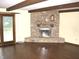 Living room boasting hardwood floors, decorative stone fireplace, wooden beams and natural light at 60 Bittersweet Ct, Noblesville, IN 46062
