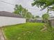 Fenced backyard featuring garage and brick pathway at 602 W 34Th St, Anderson, IN 46013