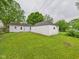 Spacious backyard featuring house and garage with green lawn at 602 W 34Th St, Anderson, IN 46013