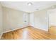 Comfortable bedroom featuring hardwood floors, neutral paint, and a view into the attached bathroom at 602 W 34Th St, Anderson, IN 46013
