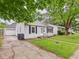 Street view of a traditional home featuring a detached garage and a neatly kept lawn at 602 W 34Th St, Anderson, IN 46013