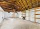 Garage interior with bare white block walls and bare wood ceiling at 602 W 34Th St, Anderson, IN 46013