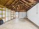 Spacious garage interior with cement floor and wooden shelves at 602 W 34Th St, Anderson, IN 46013