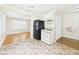 Functional kitchen with linoleum floors, a black refrigerator, and an attached dining area at 602 W 34Th St, Anderson, IN 46013