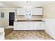Simple kitchen with ample cabinet space, linoleum floors, and classic white trim at 602 W 34Th St, Anderson, IN 46013