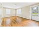 Bright living room with hardwood floors, neutral walls, and ample natural light from multiple windows at 602 W 34Th St, Anderson, IN 46013