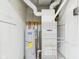 Water heater and furnace in a room with white walls and cement floor at 602 W 34Th St, Anderson, IN 46013