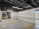 Unfinished basement showing open layout and shelving, offering flexible space for various uses and storage solutions at 6069 E 15Th St, Indianapolis, IN 46219