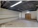 Unfinished basement offers ample storage space and potential for customization with exposed ceiling and concrete floor at 6069 E 15Th St, Indianapolis, IN 46219