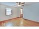 Bright bedroom features hardwood floors and a view into the ensuite bathroom at 6069 E 15Th St, Indianapolis, IN 46219