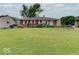 Charming brick home featuring a lush front lawn and manicured landscaping at 6069 E 15Th St, Indianapolis, IN 46219
