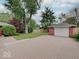 The detached single-car garage complements the property, complete with a paved driveway and well-kept landscaping at 6069 E 15Th St, Indianapolis, IN 46219