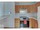 Well-lit kitchen featuring stainless steel appliances and wooden cabinets at 6069 E 15Th St, Indianapolis, IN 46219