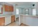Open-concept kitchen with breakfast bar and white appliances, perfect for casual dining at 6069 E 15Th St, Indianapolis, IN 46219