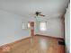 Cozy living room with hardwood floors leading to the kitchen area with a window at 6069 E 15Th St, Indianapolis, IN 46219