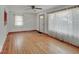 Living room with hardwood floors, large windows, and a white entry door at 6069 E 15Th St, Indianapolis, IN 46219