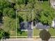 Birds-eye view of a home with a driveway and well-manicured lawn surrounded by lush trees at 6143 E 43Rd St, Indianapolis, IN 46226