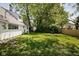 A spacious backyard offers a large grassy area and mature trees at 6143 E 43Rd St, Indianapolis, IN 46226