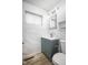 Bathroom featuring marble tiling, modern fixtures, and a stylish vanity at 6143 E 43Rd St, Indianapolis, IN 46226