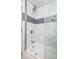 Bright bathroom features a shower and tub combination and updated tile surround at 6143 E 43Rd St, Indianapolis, IN 46226