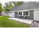 Close-up of a charming home's entry with seating, featuring a secure front door and fresh landscaping at 6143 E 43Rd St, Indianapolis, IN 46226