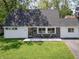 Charming Cape Cod-style home with a manicured lawn and a cozy front porch seating area at 6143 E 43Rd St, Indianapolis, IN 46226