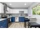 Open kitchen with stainless appliances, two-tone cabinets, and eat-in dining area at 6143 E 43Rd St, Indianapolis, IN 46226