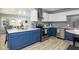 Modern kitchen featuring stainless appliances, gray backsplash, and a large kitchen island at 6143 E 43Rd St, Indianapolis, IN 46226