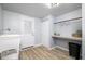 Bright laundry room with sink, shelving, storage, and a convenient utility sink at 6143 E 43Rd St, Indianapolis, IN 46226