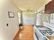 Efficient kitchen with white appliances, window, and light wood-look flooring at 620 W Central Ave, Greensburg, IN 47240