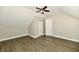 Attic bedroom featuring neutral paint, wood-look flooring, vaulted ceilings, and a built in closet at 631 Prospect St, Indianapolis, IN 46203