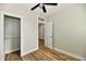 Bedroom with wood-look floors, closet, and open door to another room at 631 Prospect St, Indianapolis, IN 46203