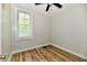Bright bedroom featuring wood-look floors, a window, and fresh paint at 631 Prospect St, Indianapolis, IN 46203