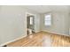 Well-lit living room features wood-look floors, fresh paint, and an open doorway to an adjoining room at 631 Prospect St, Indianapolis, IN 46203