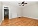 Empty living room with fireplace, hardwood floors, neutral paint, and an entry way to the kitchen at 631 Prospect St, Indianapolis, IN 46203