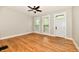 Sunlit living room with beautiful hardwood floors, neutral paint, large windows, and ceiling fan at 631 Prospect St, Indianapolis, IN 46203