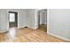 Bright living room featuring wood-look floors, fresh paint, and open doorways to adjoining rooms at 631 Prospect St, Indianapolis, IN 46203
