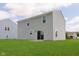Spacious backyard with lush green lawn and a two-story home at 6410 Avacado Dr, Indianapolis, IN 46217