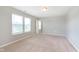 Bedroom with neutral walls, carpet, and windows that provide natural light at 6410 Avacado Dr, Indianapolis, IN 46217