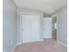 Neutral bedroom featuring carpet, closet, and an open door leading to the next level at 6410 Avacado Dr, Indianapolis, IN 46217